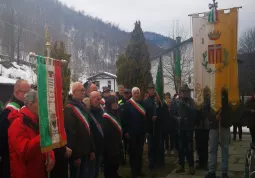 La deposizione della corona di alloro ai piedi della lapide sulla quale sono impressi i nomi dei nove partigiani