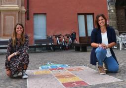 Il gioco in piazza della Rossae  le assessore alla Famiglia, Lucia Rosso, e alle Politiche giovanili, Beatrice Aimar, che seguono l’iniziativa 